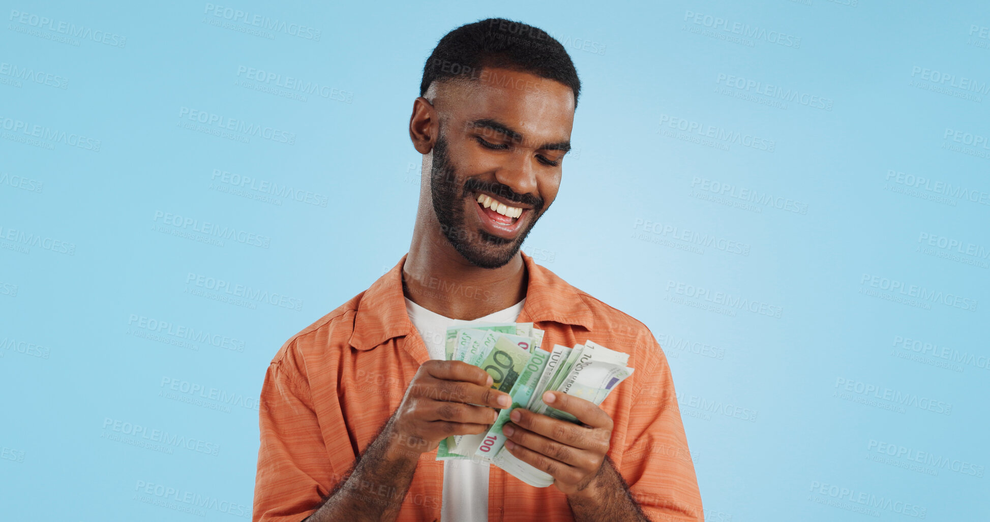 Buy stock photo Man, count cash and happy in studio with success, bonus or promotion with winning by blue background. Investor, trader or person with Euro money, salary or savings with smile for financial freedom goal