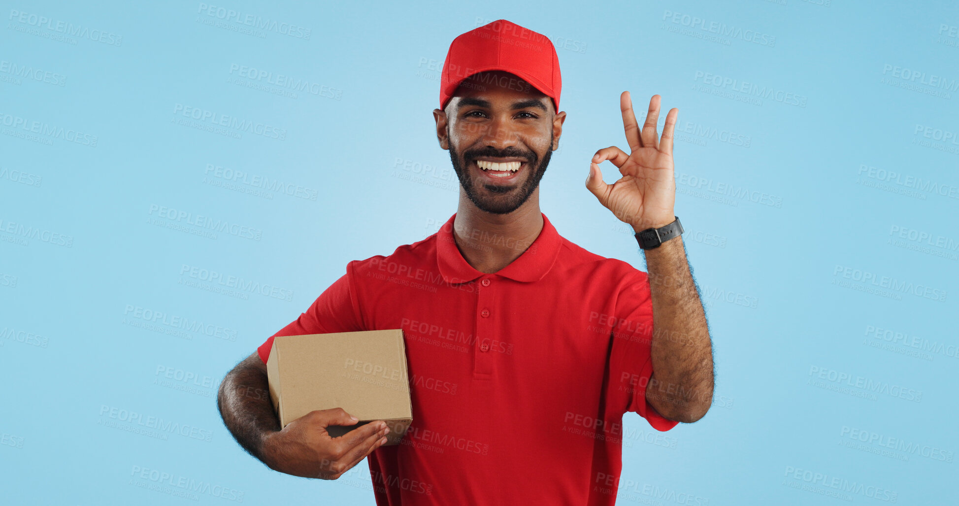 Buy stock photo Delivery man, box and okay hands for success, product excellence and courier services in studio. Happy face of supply chain worker or african person for package or distribution on blue background