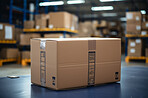 Package on warehouse table. Big warehouse in background. Delivery concept.