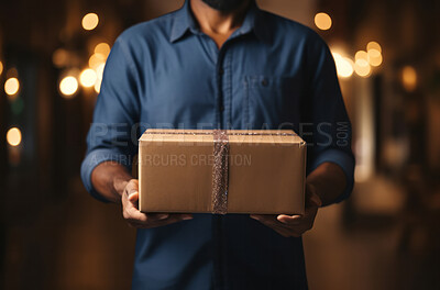 Man holding package or gift. Bokeh in background. Delivery concept.