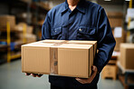 Worker holding boxes or packages in warehouse.