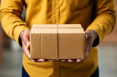 Delivery man holding boxes or packages in street.