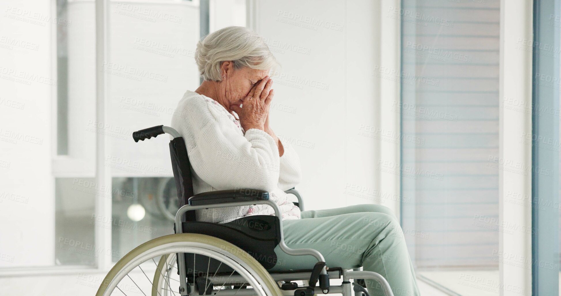 Buy stock photo Sad, senior woman and person with disability, wheelchair and crying into hands at the hospital, window or nursing home. Depressed, mental health and elderly person frustrated, thinking in retirement