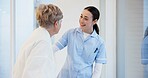 Hospital, talking and senior woman with nurse for medical care, hospice service and support. Healthcare, nursing home and female health worker with elderly patient for conversation, help and empathy