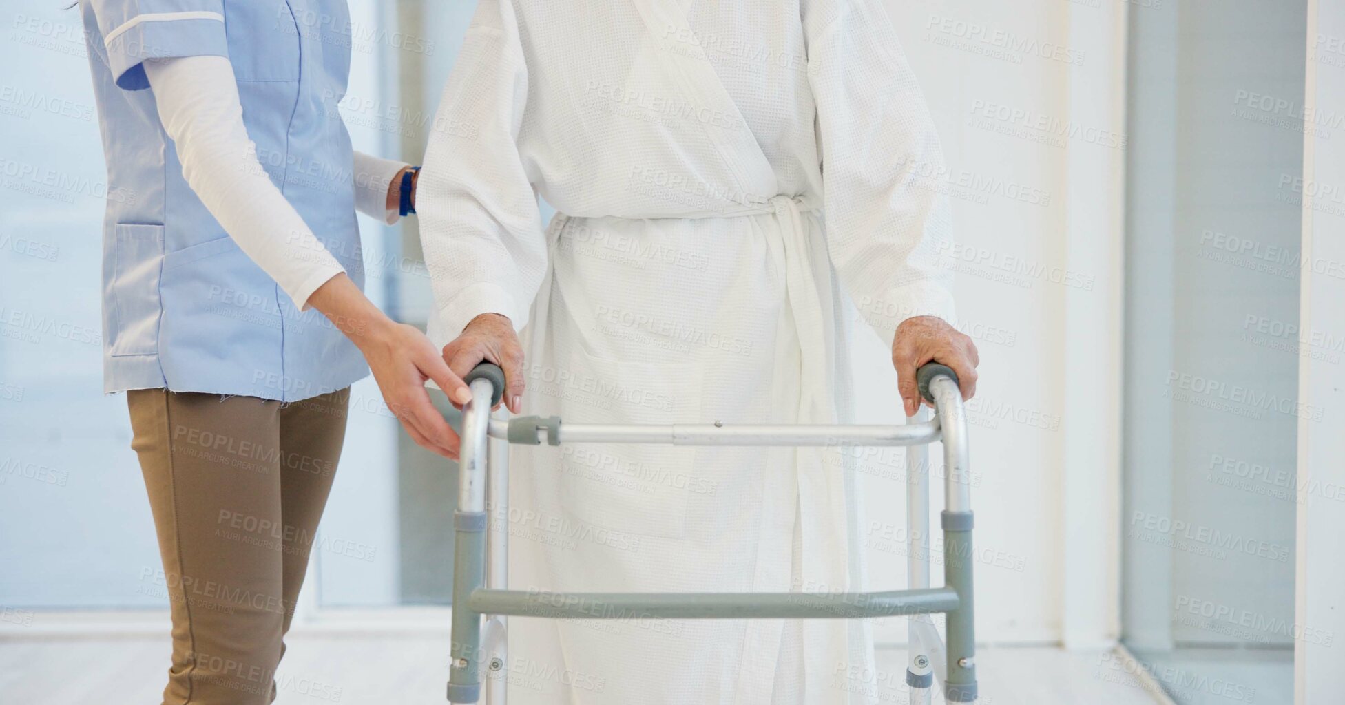 Buy stock photo Hands, mobility walker and a nurse with a patient in a clinic for assistance in walking during recovery. Assisted living, balance or rehabilitation with a caregiver and senior patient in a hospital