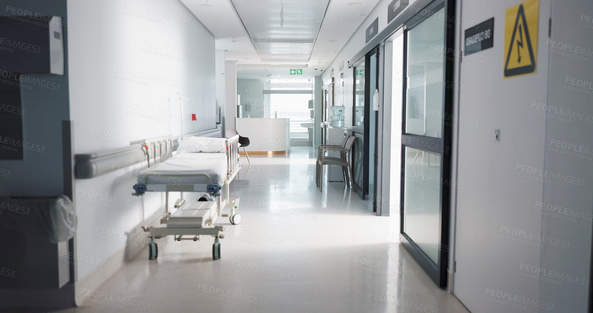 Buy stock photo Healthcare, hospital and empty hallway with bed for medical care, health insurance and help in surgery. ER, emergency and lobby at clinic with stretcher for wellness, service and support in medicine.