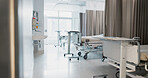 Hospital, modern and interior of bedroom or empty room for healthcare, consulting or healing. Background, medical and clinic space for emergency, rehabilitation or recovery with furniture or light