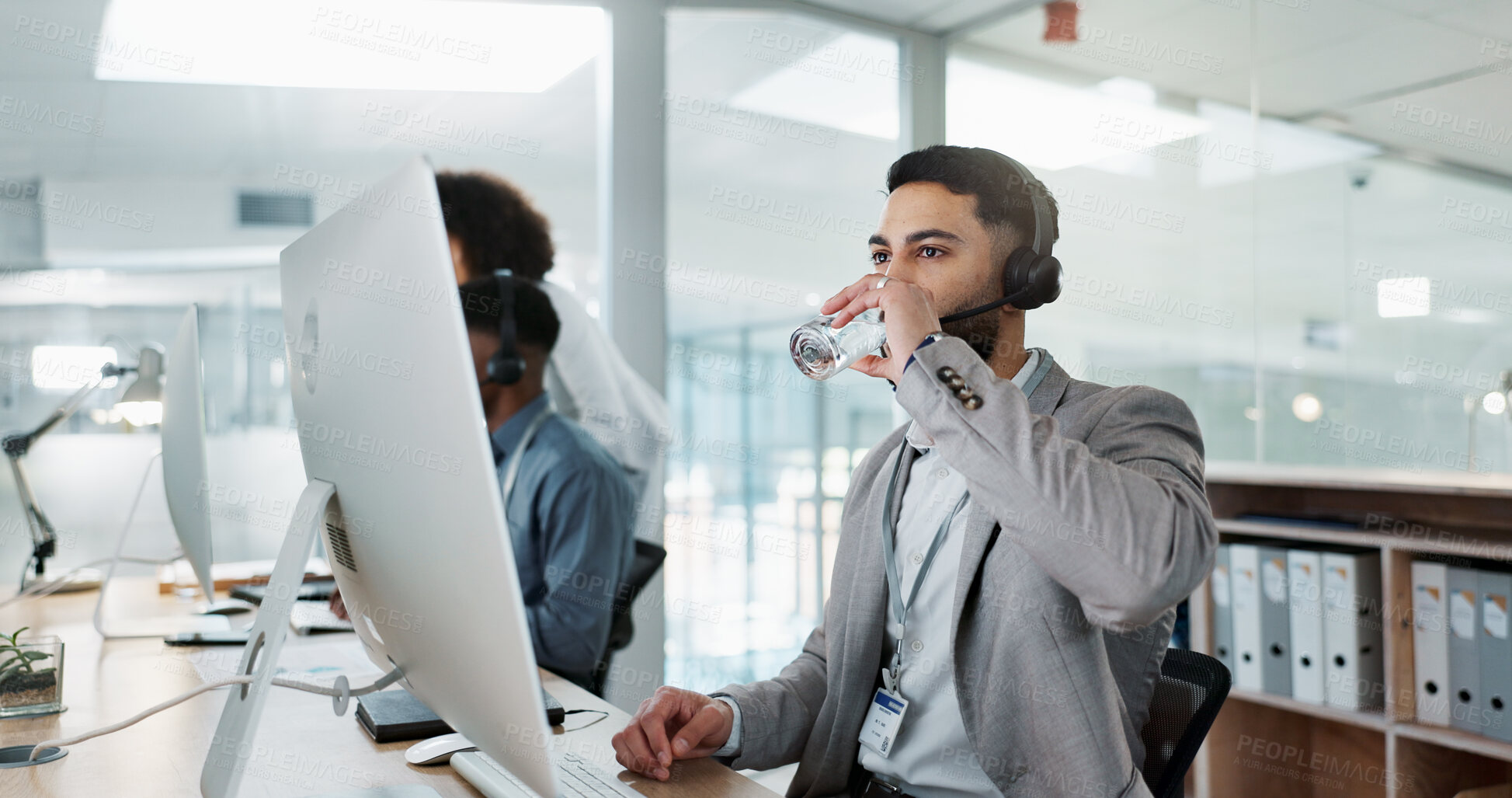 Buy stock photo Happy businessman, call center and drinking water in customer service or telemarketing at office. Thirsty man, consultant or agent talking with headphones and drink for online advice, support or help