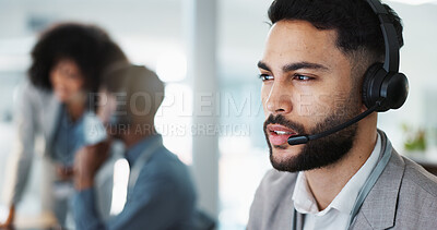 Call center, face or man speaking in CRM, telemarketing or telecom office for online customer services. Microphone headset, computer or sales agent in tech support help desk for consulting or talking