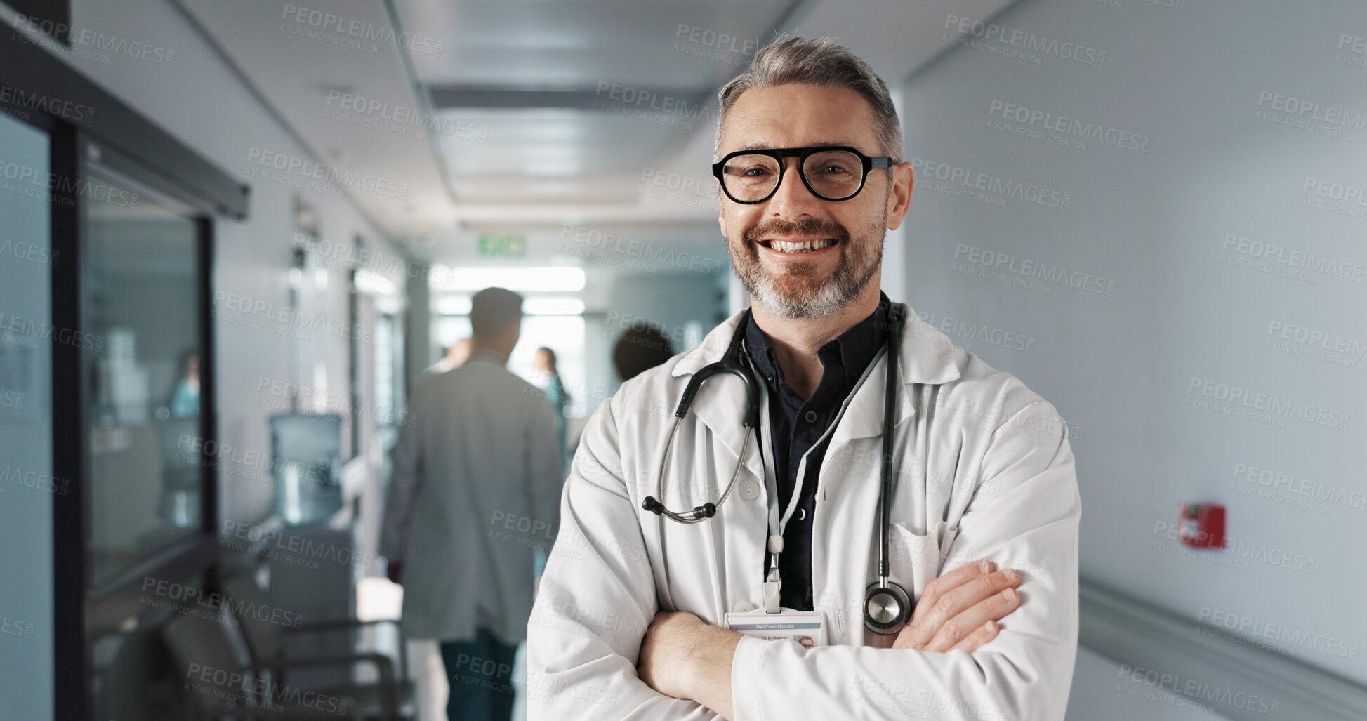 Buy stock photo Doctor in portrait, senior man with arms crossed and healthcare, smile with confidence at hospital with pride and help. Medical professional, trust and happy at clinic with expert and stethoscope