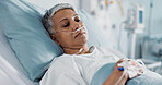 Sick, iv drip and senior woman in the hospital for consultation, surgery or treatment. Healthcare, recovery and elderly female patient resting in bed after operation or procedure in a medical clinic.