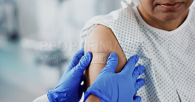 Doctor, hands and plaster on arm, vaccine and healthcare of patient in hospital. Nurse, bandage and injection of person closeup for medicine, virus immunity or help with treatment of injury in clinic