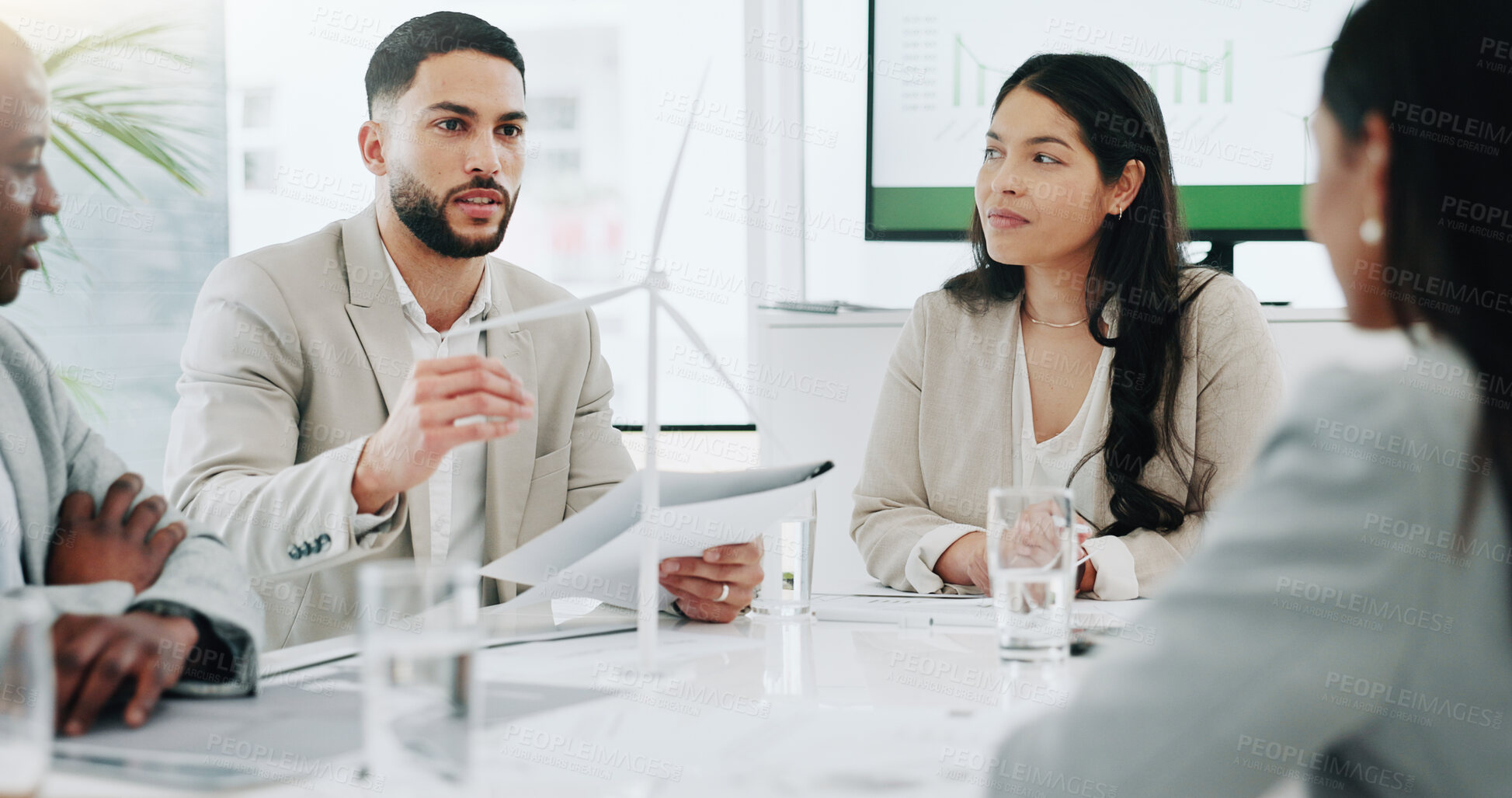 Buy stock photo Business people, renewable energy and windmill in team discussion or meeting for proposal or planning. Diversity, future or men and women talk technology development, collaboration and innovation