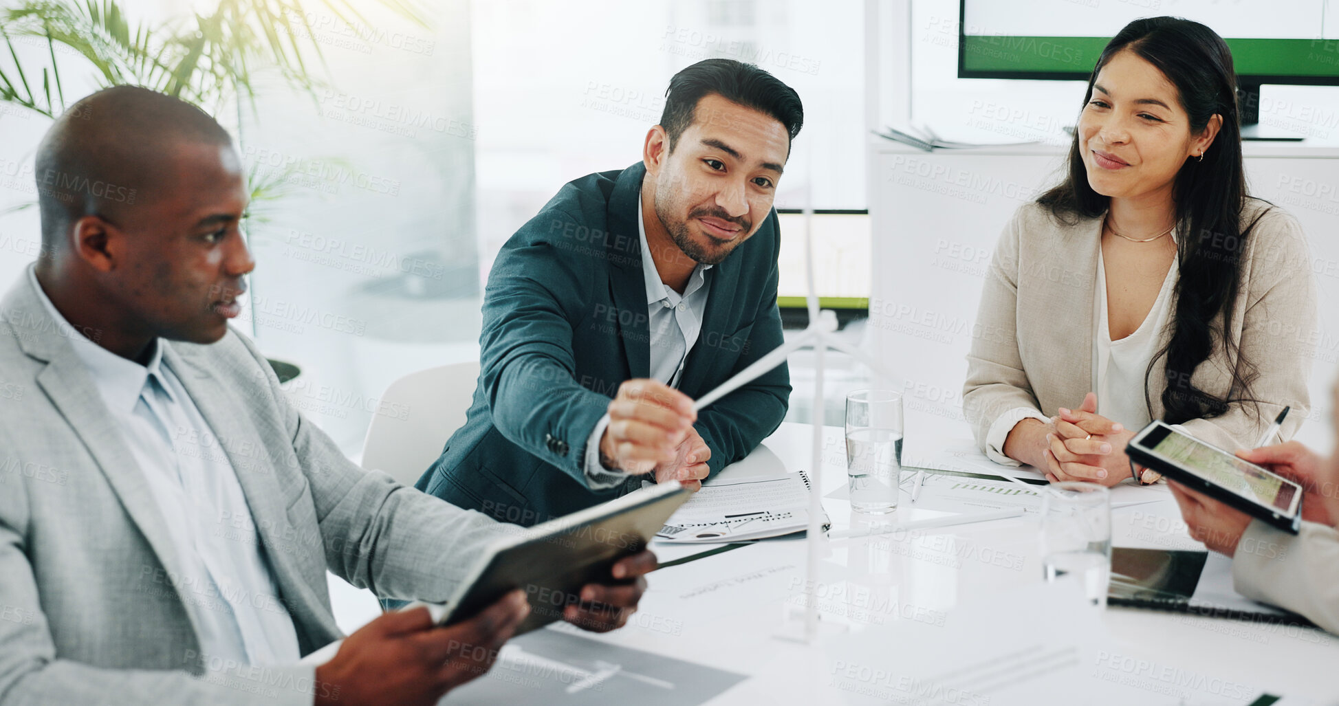 Buy stock photo Business people, renewable energy and windmill in team discussion or meeting for proposal or planning. Diversity, future or men and women talk technology development, collaboration and innovation