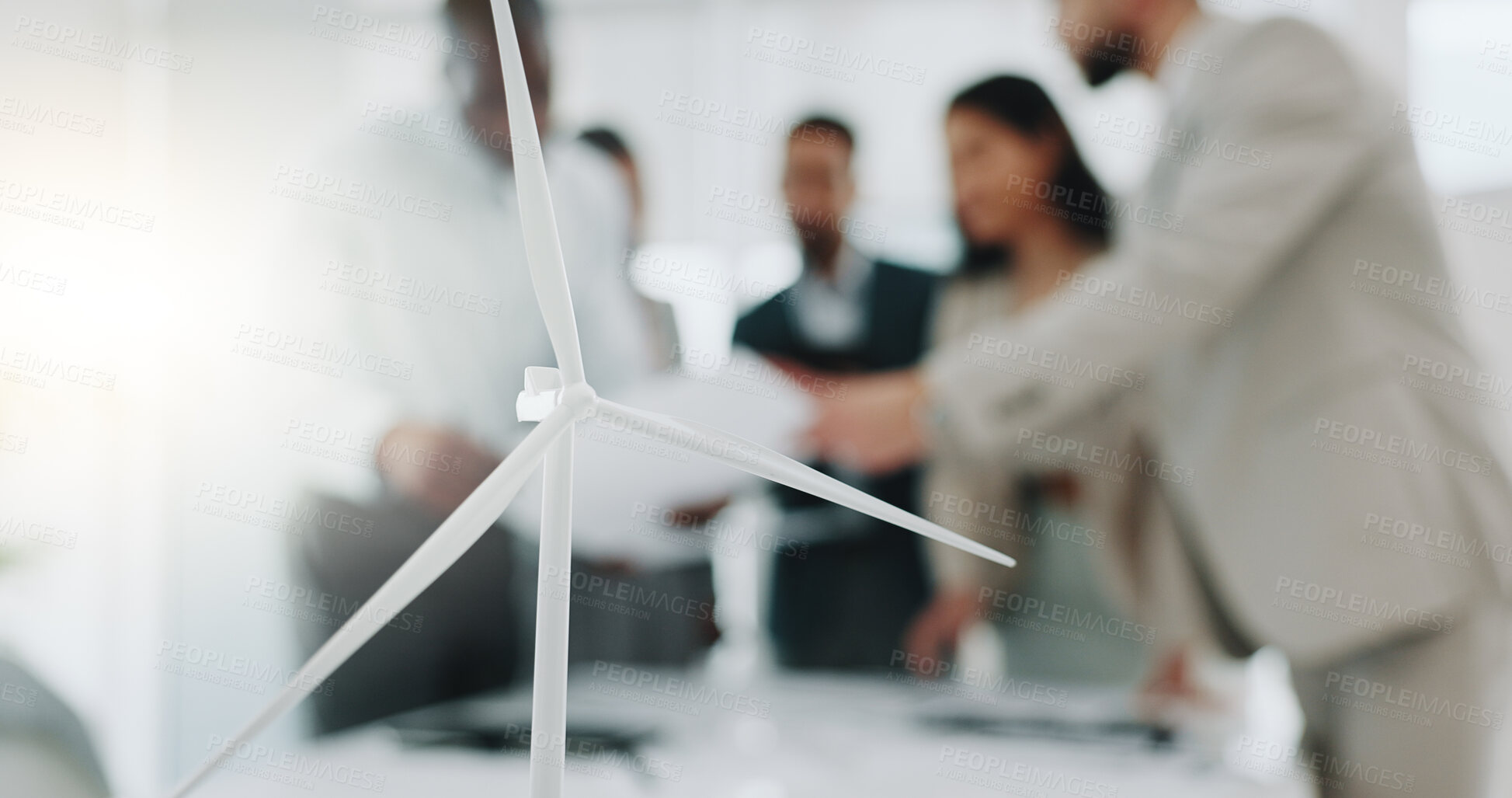 Buy stock photo Business people, meeting and wind turbine for eco friendly, sustainability and renewable energy planning in office. Windmill model, design and engineering team with documents in agriculture solution