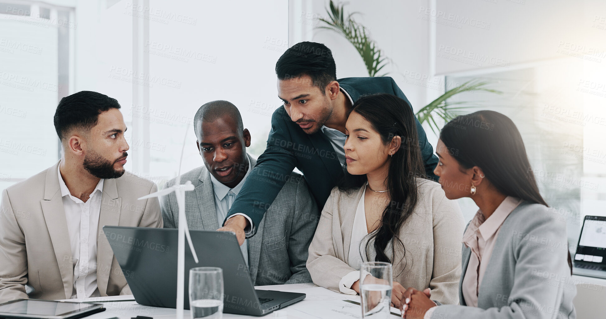 Buy stock photo Business man, windmill and presentation in office with laptop, energy and sustainable future. Engineering consultant, leader and team for brainstorming, wind power and electricity on pc with speech