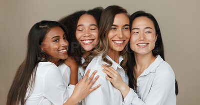 Women, group skincare and beauty with love, hug and support in diversity and inclusion on brown studio background. Friends, model or people smile together and kiss in dermatology, skin care or makeup