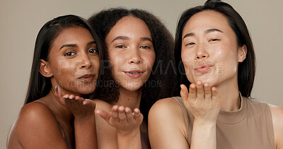 Beauty, women or friends blow kiss in studio for diversity, inclusion and wellness. Face of happy people on neutral background for different facial care, dermatology glow or makeup and cosmetics