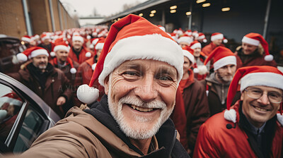 Selfie of happy senior in street with big group in background. Wearing christmas caps smiling.
