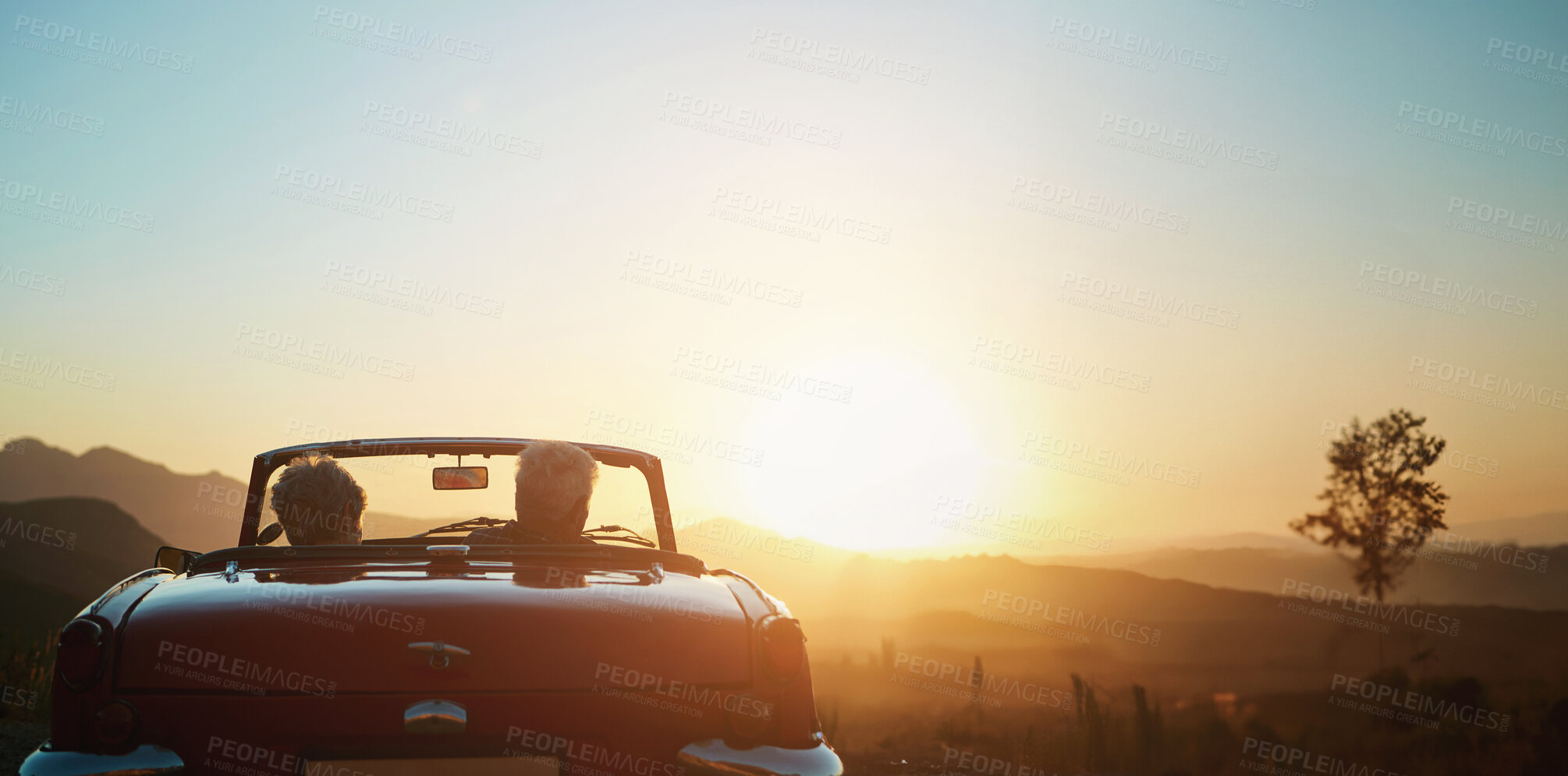 Buy stock photo Back, sunset and a senior couple on a road trip in a convertible car for travel, freedom or adventure together. Love, mockup or view of nature with an elderly man and woman in a vehicle for a drive