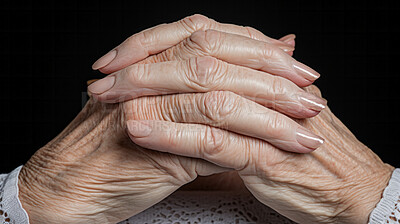 Senior woman praying hands, or hopeful wrinkled hands. Cropped hand close-up