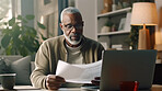 Laptop, documents and finance with a senior man busy on a budget review or pension fund