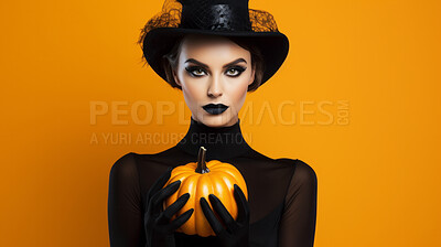 Buy stock photo Attractive woman wearing a witch costume and holding a pumpkin on orange background