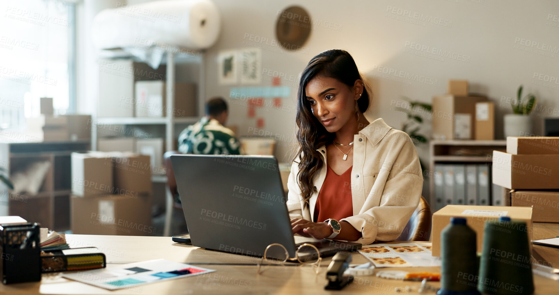 Buy stock photo Fashion, woman and reading on laptop in office for research, feedback and supply chain for business. Indian, person and planning on pc for logistics, stock administration or package distribution data