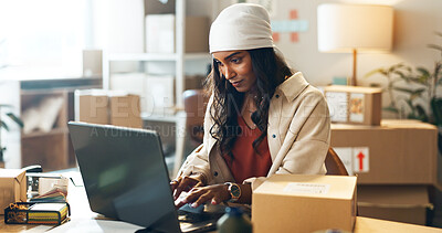 Woman, laptop and typing in small business logistics for order, ecommerce or design at boutique. Female person, tailor or fashion designer on computer for inventory, storage or inspection at store