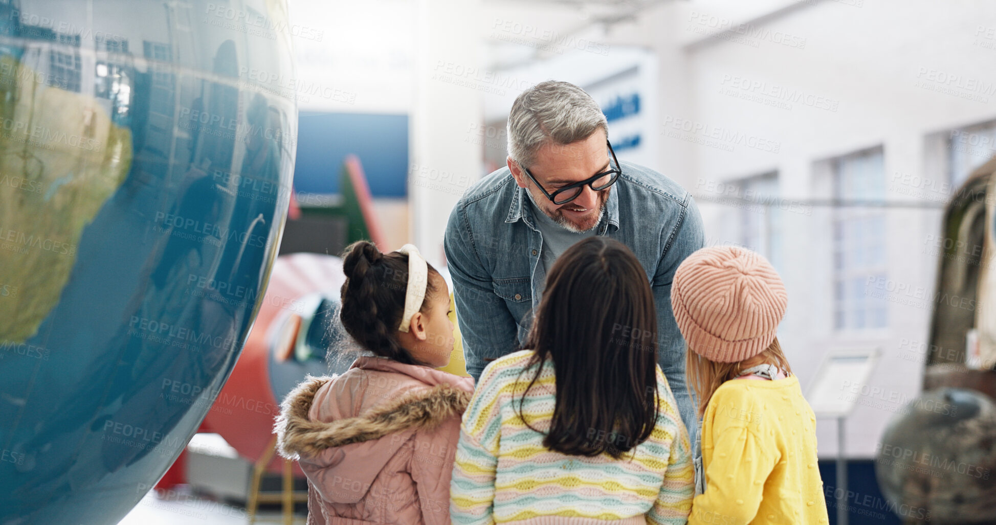 Buy stock photo Science, geography and kids learning about the earth with a teacher at school for growth or development. World, globe or planet with a man teaching students about climate change or global warming