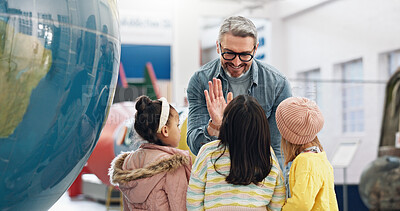 Buy stock photo Science, high five and students learning about the earth with a teacher at school for child development. Planet, support or motivation with a man teaching kids about climate change or global warming