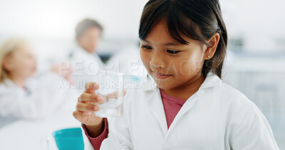 Science, glass beaker and a student girl in a classroom for education or learning about chemistry. School, laboratory or class with a young child looking at a chemical reaction for an experiment