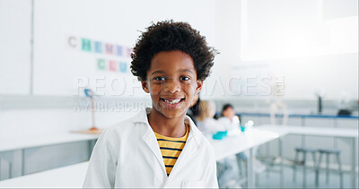 Portrait, boy and child in classroom with lab coat, knowledge or learning about chemistry with smile. Face, student and kid with happiness in laboratory, workshop or academy for education or study