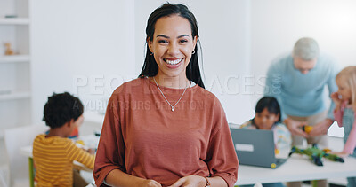 Portrait, woman and happy teacher in classroom at kindergarten for education. Face, smile and professional educator or worker with children, students and kids learning, knowledge and study at school
