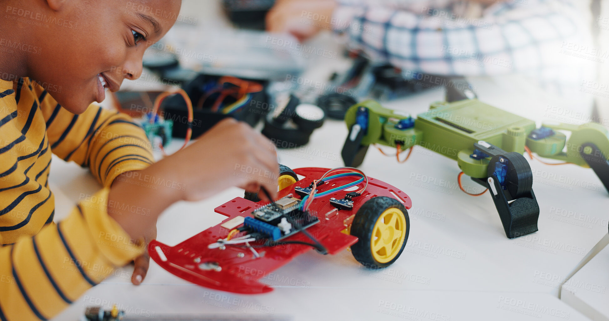 Buy stock photo Robotics, boy and technology in classroom for education or learning electronics with car toys for innovation. School kids, learners and transportation knowledge in science class for research or study