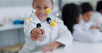 Child, molecular structure and education, learning science or knowledge in classroom or school laboratory. Happy portrait of kid with atom or molecule model for scientist, project and happy physics 