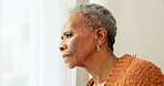 Senior woman, face and thinking by window at home to remember memory and relax in retirement. Serious black elderly person or old lady at nursing facility with hope, sad emotion and Alzheimer disease