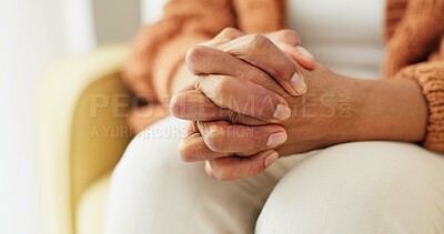 Hands, stress and senior woman on a sofa with anxiety, fear or grief, dementia or scared in her home. Stress, worry and nervous elderly female in a living room with Alzheimer, arthritis or depression