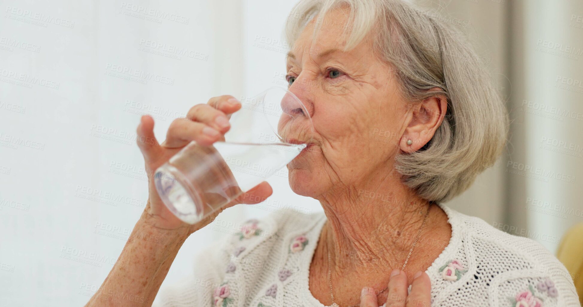 Buy stock photo Health, thirsty and mature woman drinking water for hydration and liquid diet detox at home. Wellness, fresh and calm elderly female person enjoying glass of cold drink in modern retirement house.