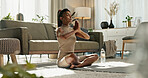 Woman, stretching and lotus pose with yoga on living room floor, exercise or mental health at home. Indian, person or  fitness in workout or pilates, healthy body or meditation in wellness or balance