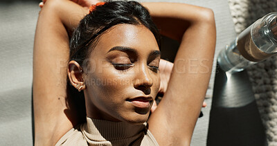 Buy stock photo Face, relax and fitness with an indian woman on the floor of her home from above for a workout rest. yoga, exercise and a young sports person resting while training for mental health or wellness