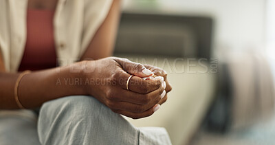 Anxiety, hands and closeup of woman on a sofa with fear, worry or mental health crisis at home. Stress, zoom and female person in living room with conflict trauma, ptsd or disaster, mistake or abuse