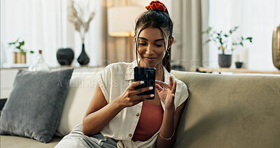 Woman, typing and scroll on cellphone, social media post and update subscription app on sofa at home. Happy indian girl, smartphone and download mobile games, reading notification and chat to contact
