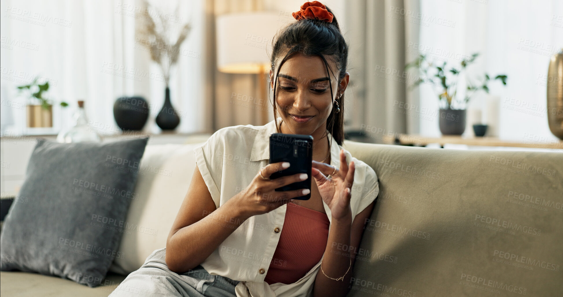 Buy stock photo Woman, typing and scroll on cellphone, social media post and update subscription app on sofa at home. Happy indian girl, smartphone and download mobile games, reading notification and chat to contact