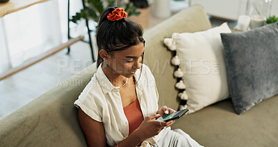 Buy stock photo Woman, typing and scroll on smartphone in home for social network, update multimedia subscription or chat on sofa from above. Indian girl, phone and download mobile games, reading notification or app