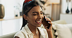 Phone call, laughing and young woman on a sofa for relaxing in the living room of apartment. Happy, smile and Indian female person on mobile conversation with cellphone in lounge of modern home.