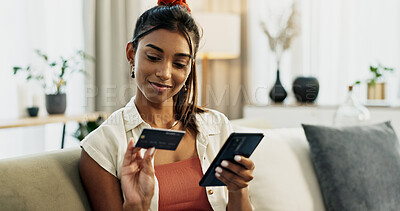 Woman, credit card and phone on sofa, check and reading with cybersecurity, fintech and bank info in home. Girl, smartphone and payment with password, budget or online shopping on e commerce website