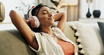 Buy stock photo Woman, headphones and relax with music, sofa and peace with sound, smile or hearing in home living room. Girl, listening and audio streaming subscription on lounge couch, happy or radio show in house