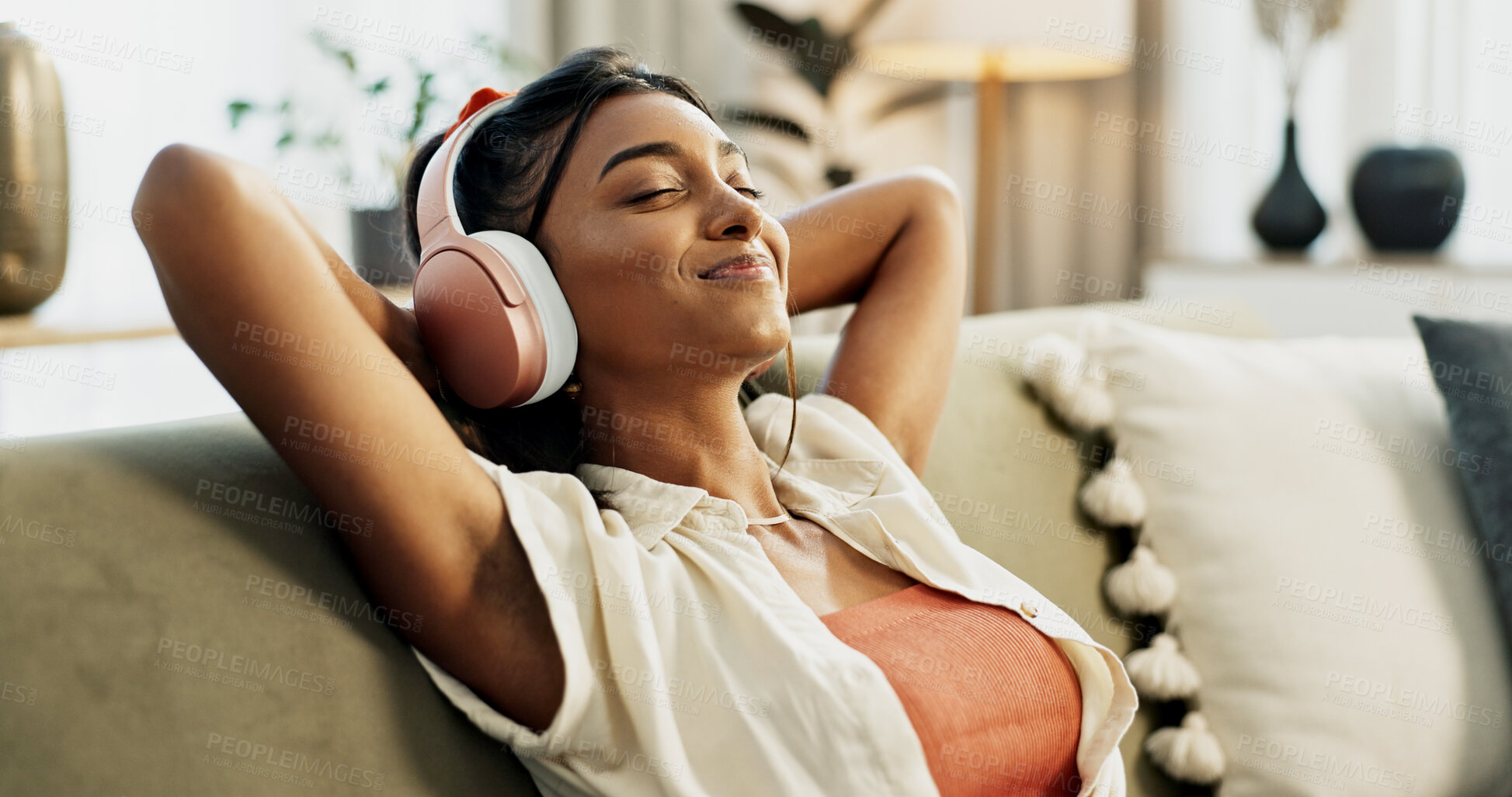 Buy stock photo Woman, headphones and relax with music, sofa and peace with sound, smile or hearing in home living room. Girl, listening and audio streaming subscription on lounge couch, happy or radio show in house