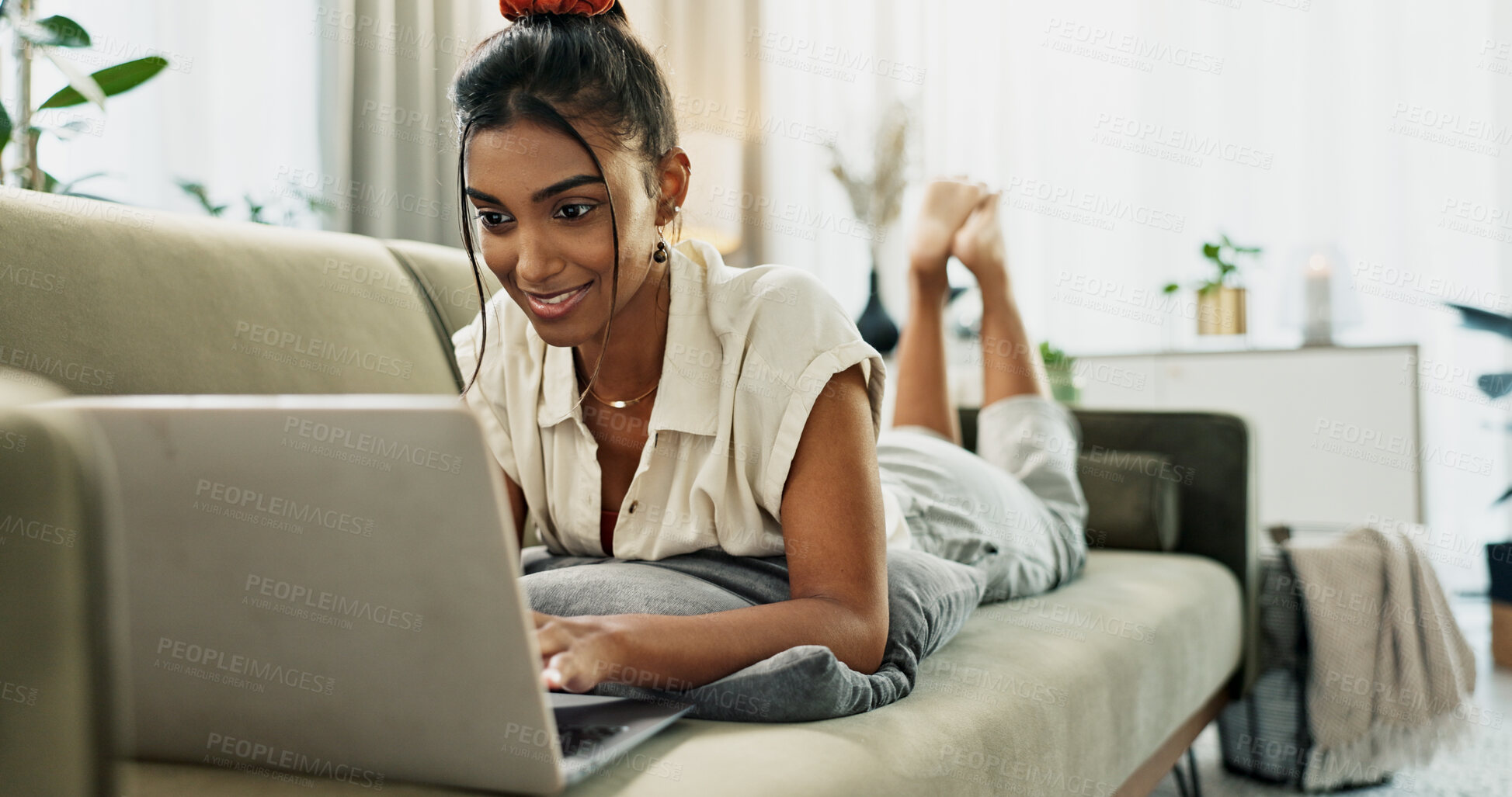 Buy stock photo Woman, laptop and typing on sofa, relax and reading for search, thinking or e learning in home living room. Student, girl and computer on lounge couch, online course or happy for post on social media